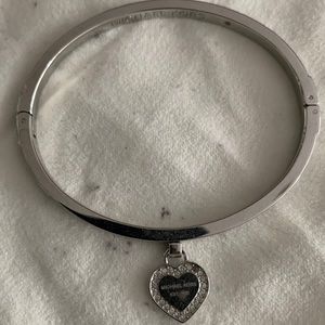 Michael Kors silver bangle with heart charm. Never been worn.